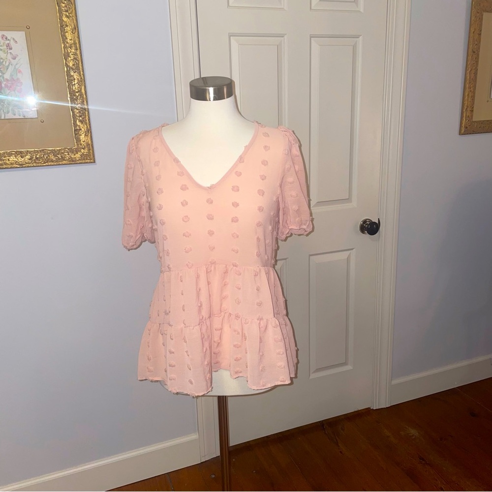 Adorable light pink polka dot blouse with ruffle hem